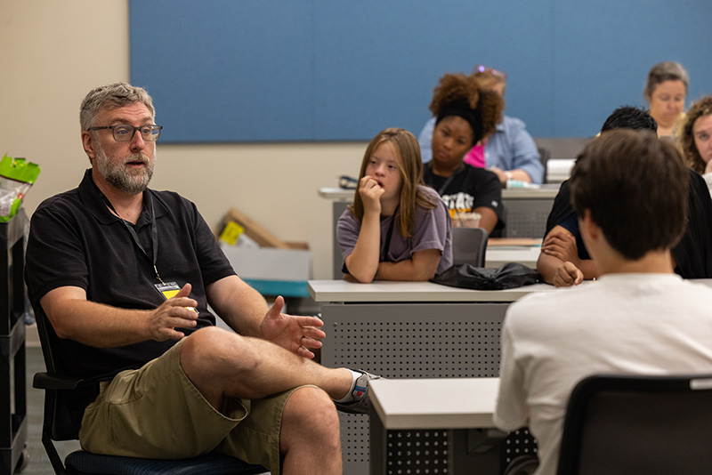 Dr. Joe Klein talks to Camp Jean Rankin campers about his personal struggle with stuttering during a group session