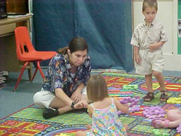 Employee working with two small children